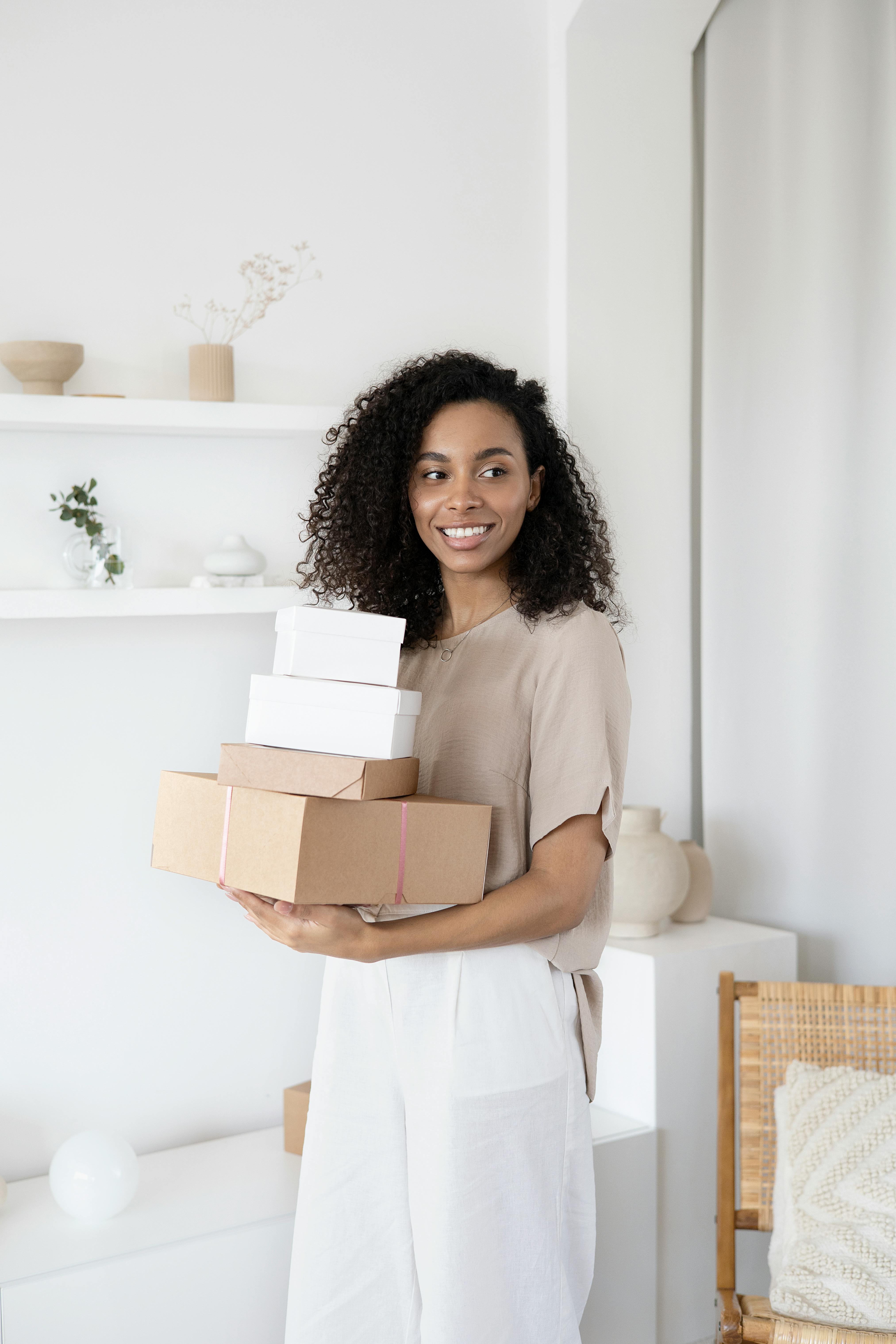 a woman holding cardboard boxes