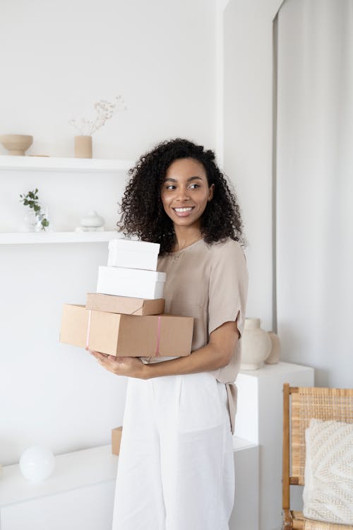Free A Woman Holding Cardboard Boxes Stock Photo