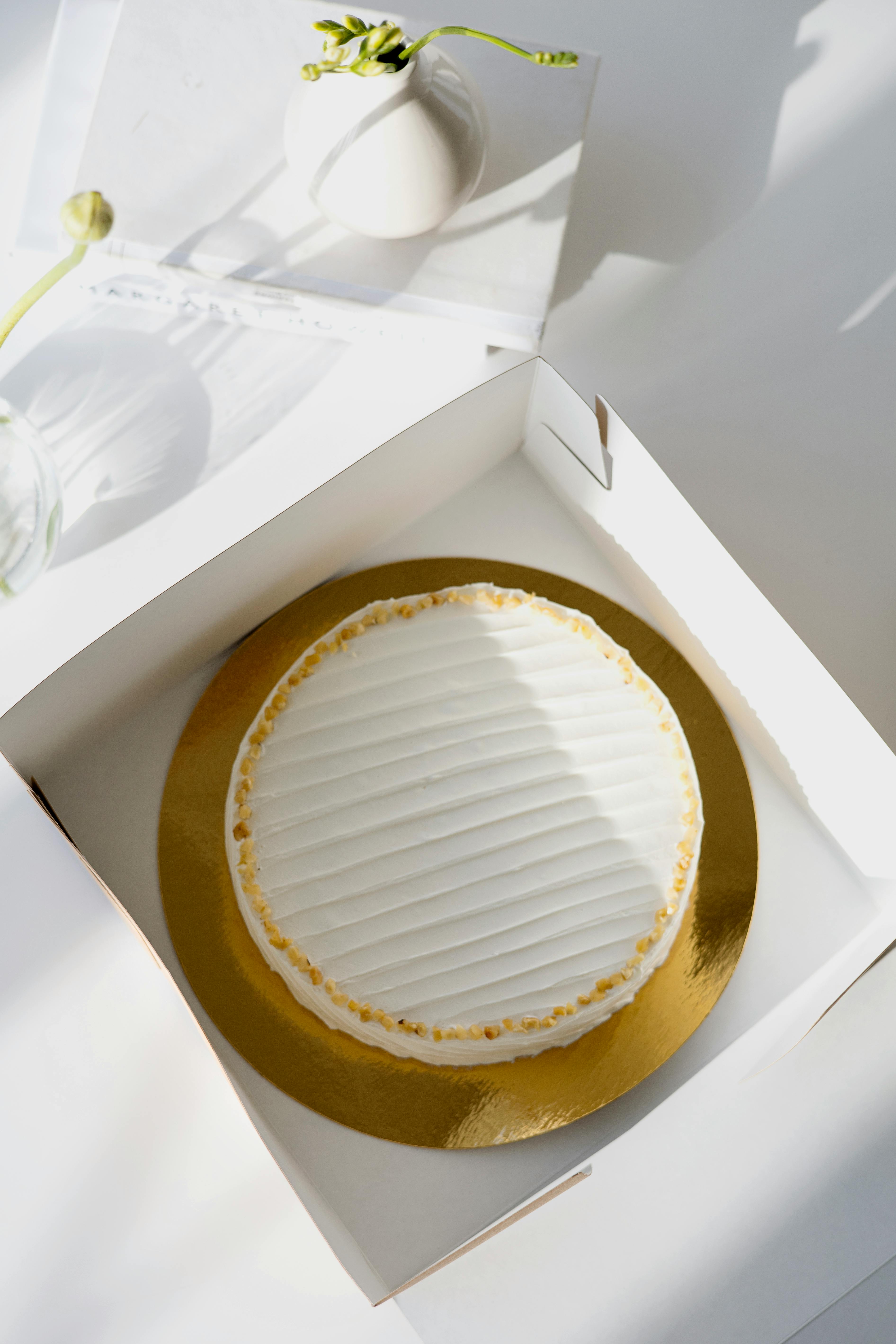 gold and white cake on white box