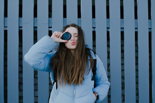 Woman Holding up Thermal Cup Lid to her Face