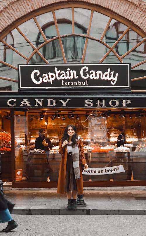 Woman Posing in Front of Candy Shop