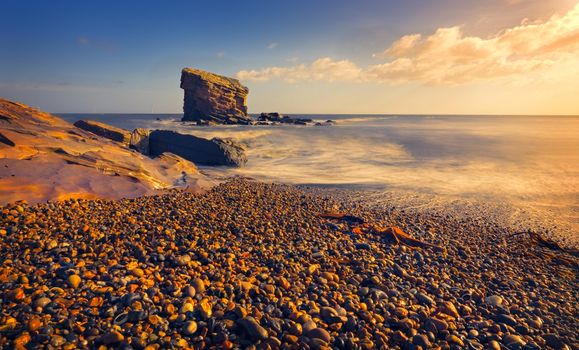 Sea and the Beach with Colorful Pebbles