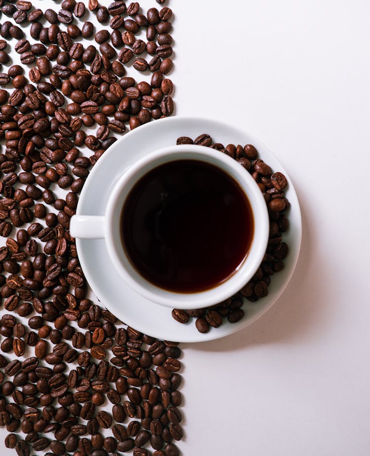 Background Of Cup With Coffee Beans