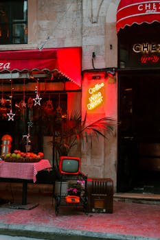 Vintage cafe scene with neon lights, fruit displays, and cozy outdoor seating, perfect for urban nostalgia.