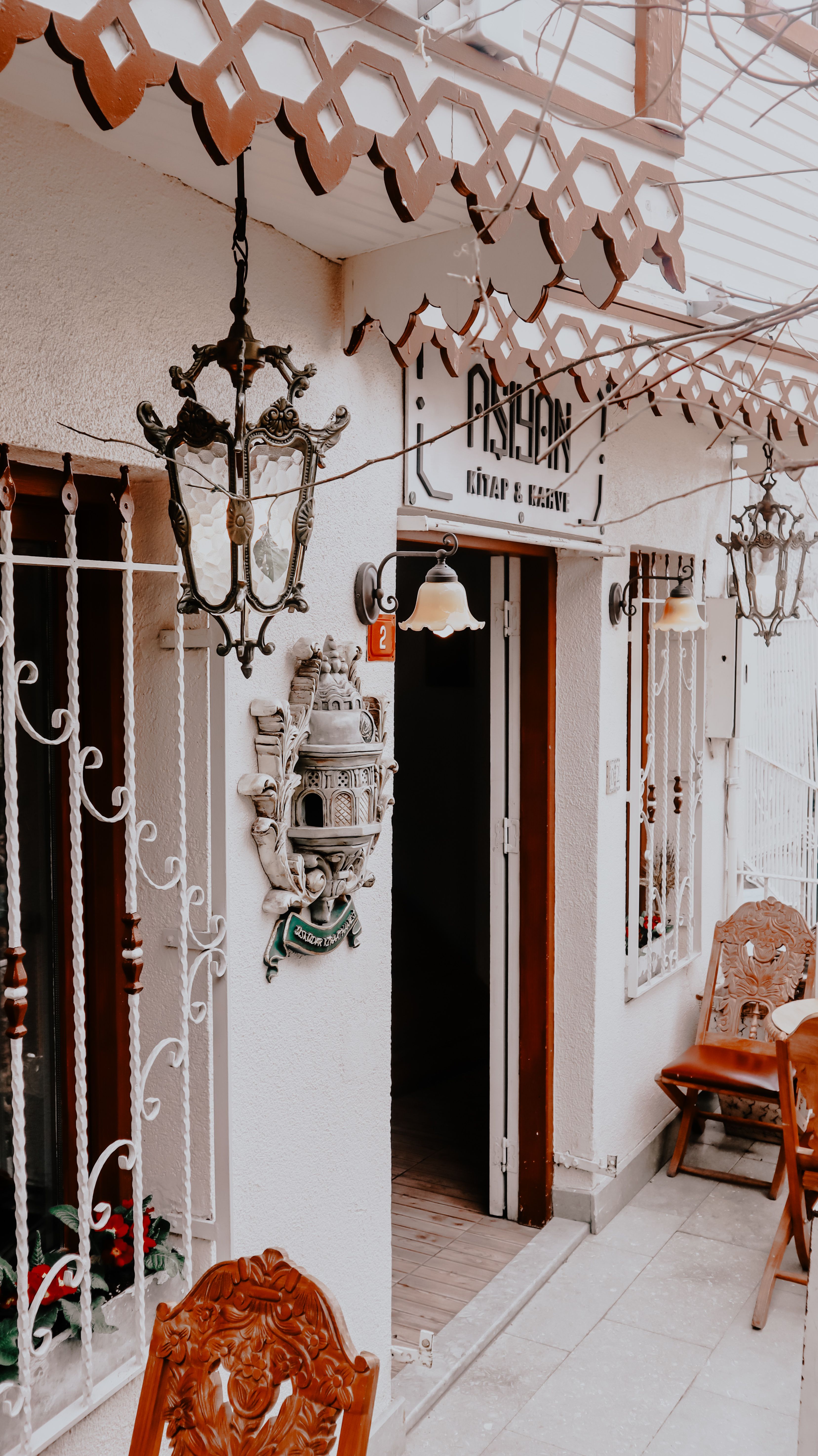 A charming café entrance with ornate vintage decor, perfect for a cozy city atmosphere.