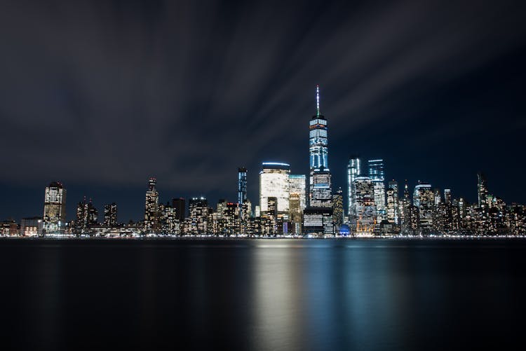 High-rise Buildings At Night Near Sea