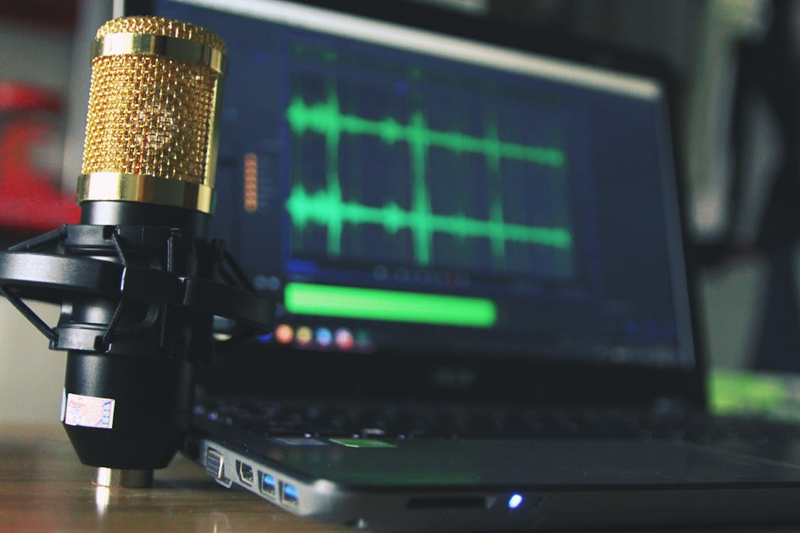 Free Gold Condenser Microphone Near Laptop Computer Stock Photo