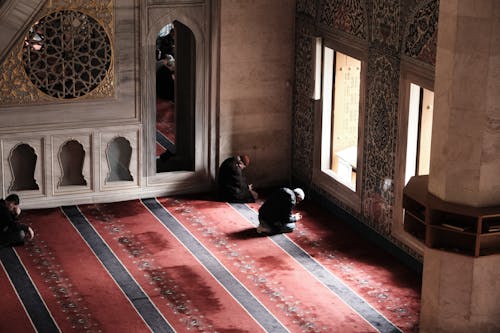 High Angle View of Men Praying on Carpet in a Mosque