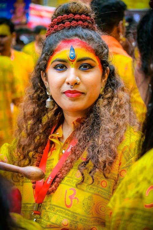 Woman in Colorful Makeup and Traditional Clothing on a Festival 