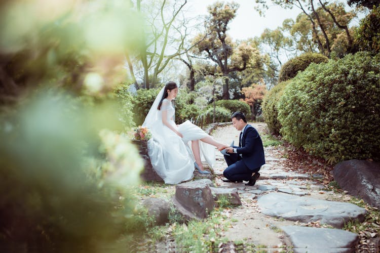 A Man Wearing Wedding Shoes To A Woman