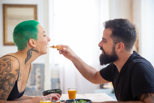 Free A Man Giving Pizza to a Woman Stock Photo