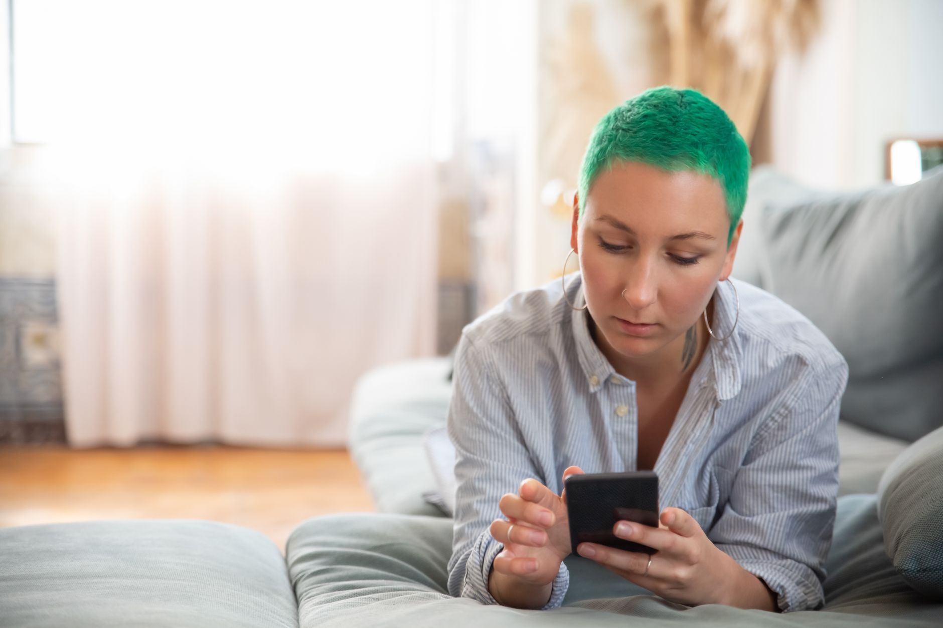 Smartphone showing deposit limits and self-exclusion settings on a calm desk with a cup of tea