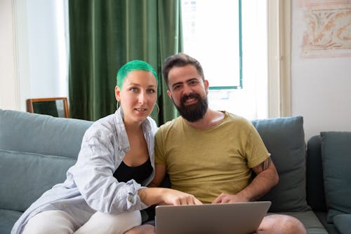 A Couple Sitting with a Laptop