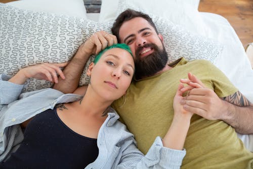 Free A Couple Lying on the Bed Stock Photo