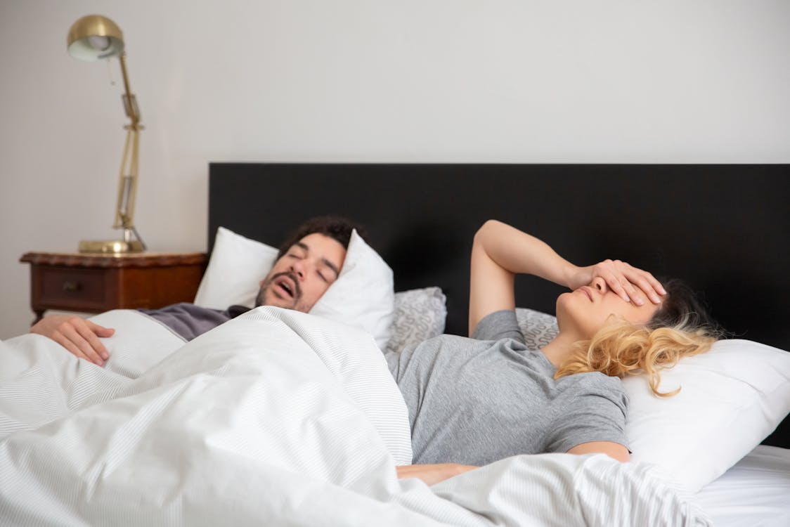 Free Man Sleeping Beside a Woman Stock Photo