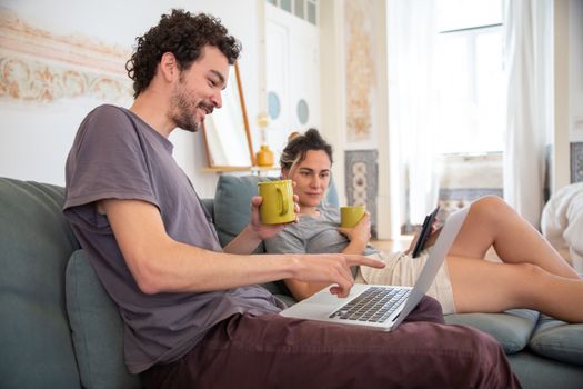 Man in Gray Crew Neck T-shirt Using Macbook Pro