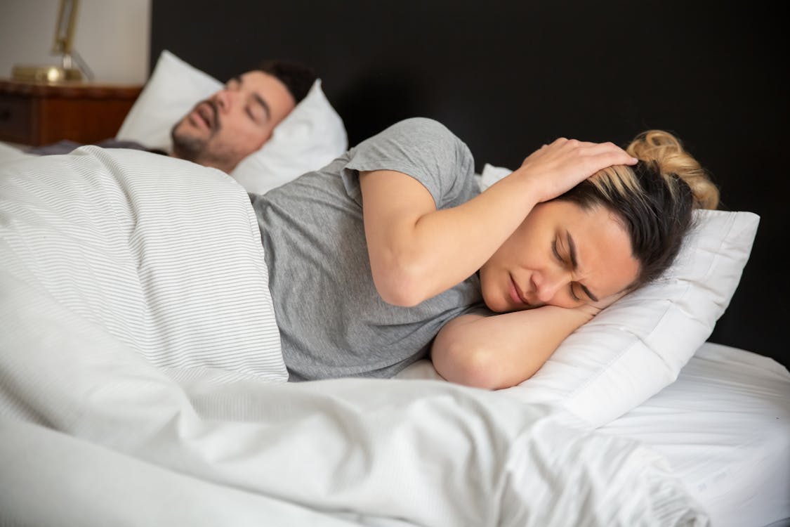 Free A Frustrated Woman Trying to Sleep Stock Photo