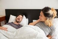 Woman in Gray Shirt Lying on Bed