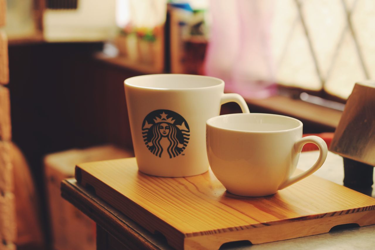 a cozy scene featuring two ceramic coffee cups on a wooden tray perfec