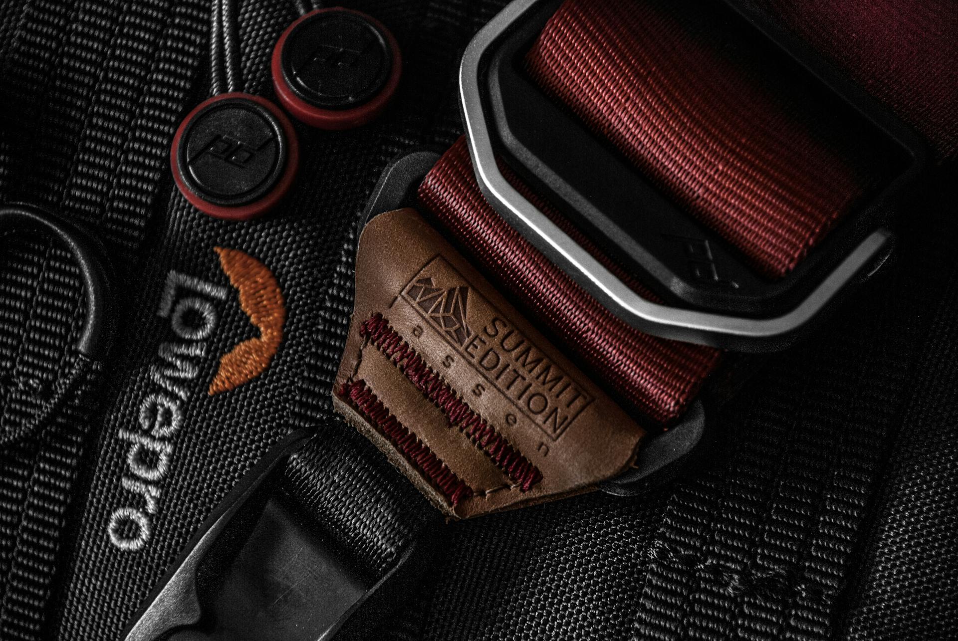 Detailed close-up of an elegant leather strap on a camera bag, showcasing craftsmanship.