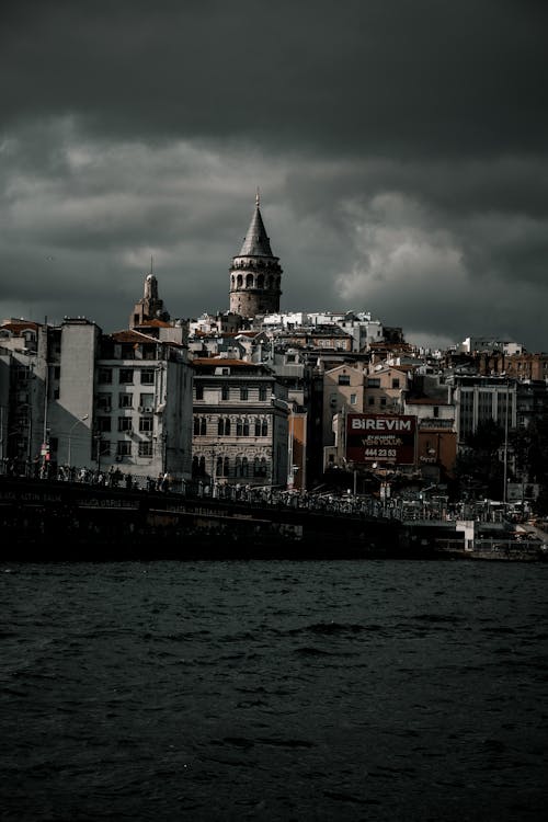 Galata Tower Behind Buildings at Cloudy Weather