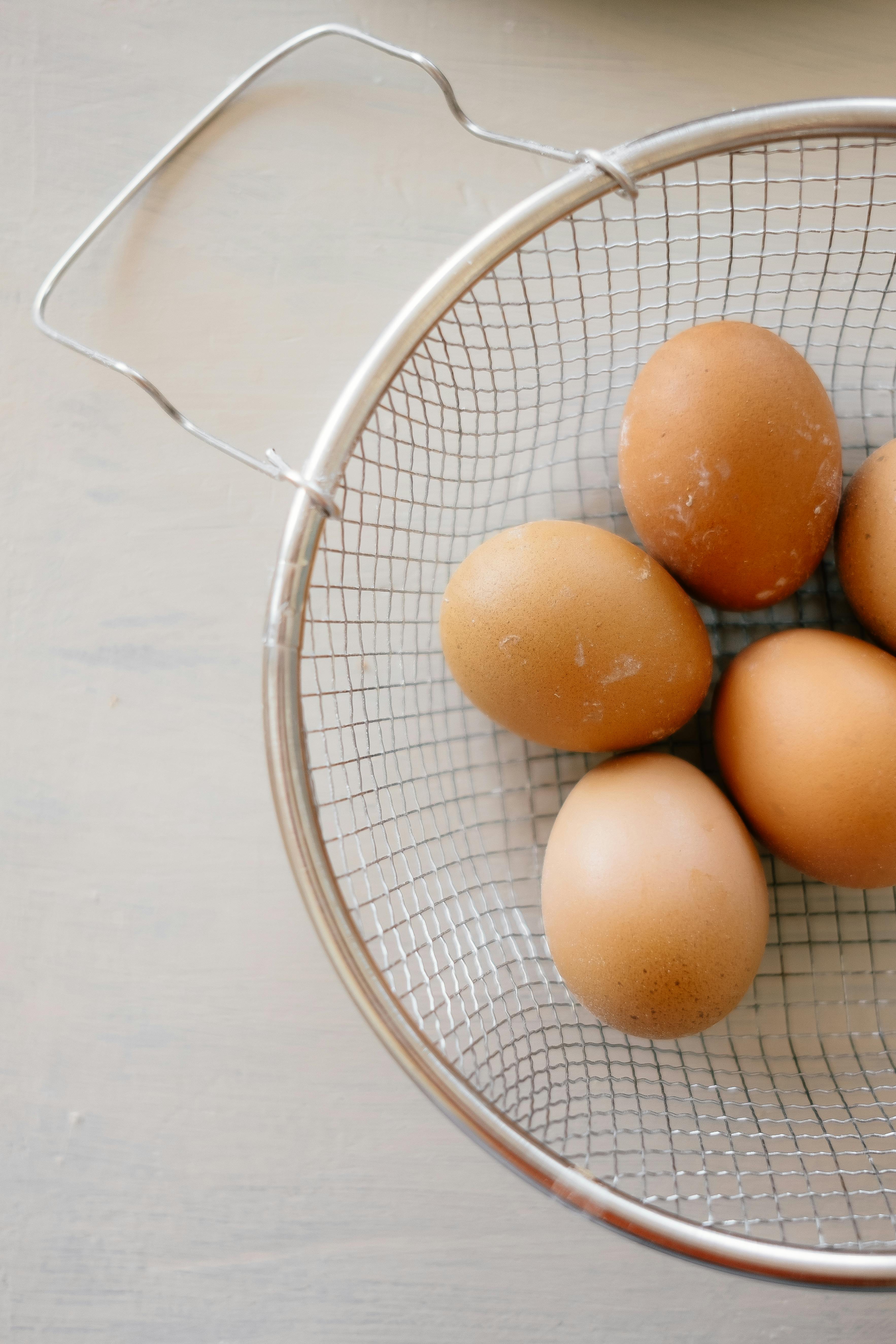 brown eggs on stainless steel basket