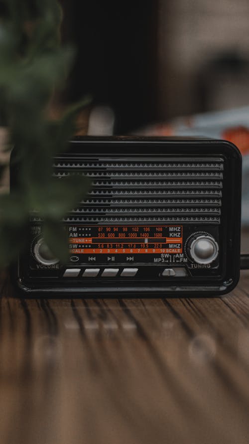 Black Radio on Brown Wooden Table