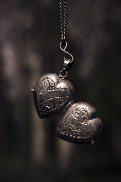 Free Close-up of a carved heart-shaped pendant necklace with intricate details. Stock Photo