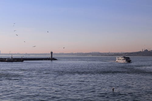 Ship floating on sea near pier