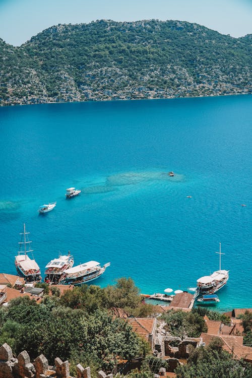 Boats in Blue Water Beside Mountain