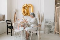 Woman Sitting on Wooden Chair