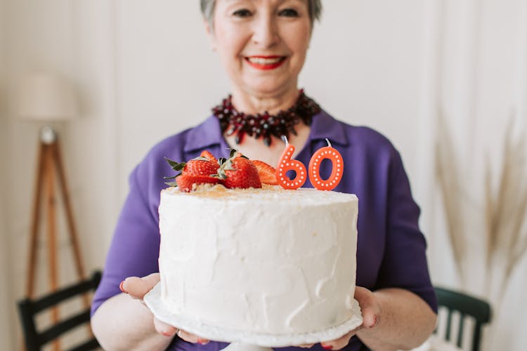 Smiling Woman Holding A Cake