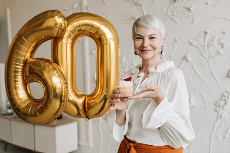 Elderly Woman Holding Cupcake