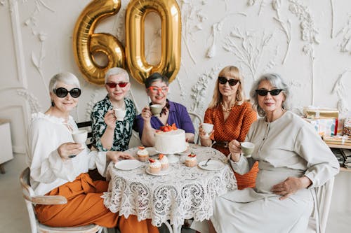 Group of Elderly Women Wearing Sunglasses and Holding Tea Cup