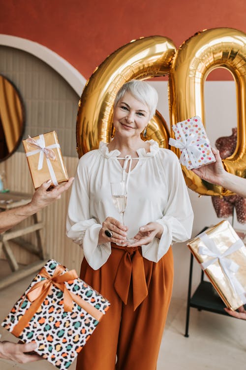 Free Elderly Woman surrounded with Gifts  Stock Photo