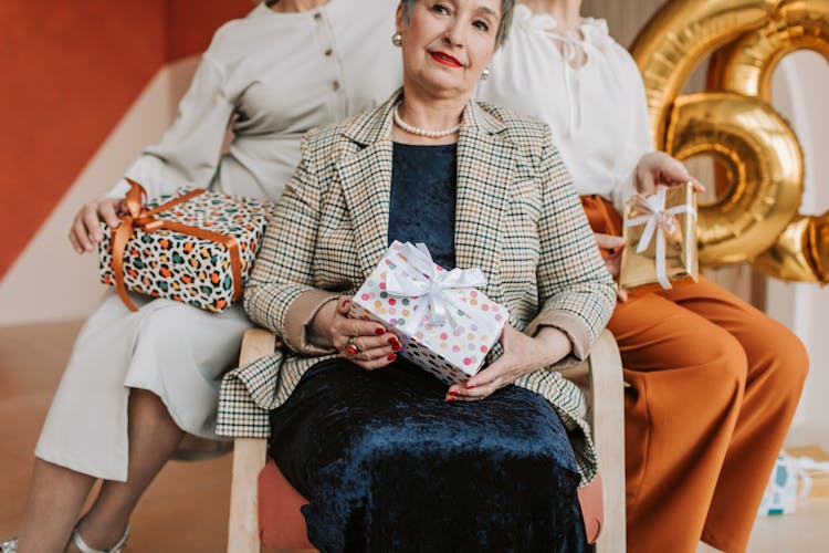 Elderly Women Holding Wrapped Gifts