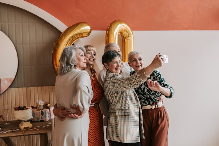 A Group Of Elderly Women Taking A Picture Together