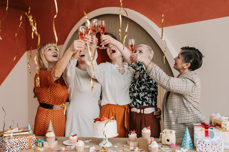 A Group Of Women Doing A Toast