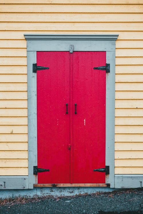 Red door of yellow house