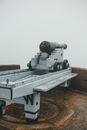 Cannon on street in misty day