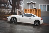 White coupe parked kerbside — photo by Erik Mclean on Pexels