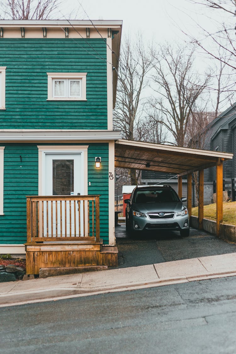 Residential House With Car Under Canopy