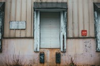 Shabby wall of building with closed window