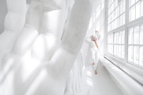 Woman in White Suit in White Room