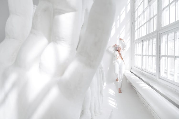 Woman In White Suit In White Room