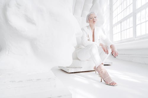 A Woman with Face Jewels Wearing a White Suit 