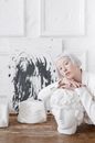 Girl in White Long Sleeve Shirt Sitting on White Chair