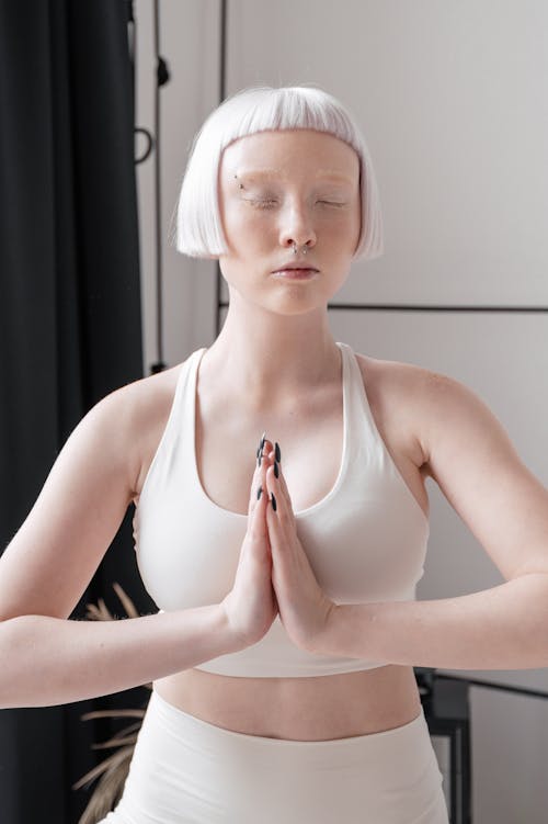 Photo of a Woman with Short Hair Meditating with Her Eyes Closed