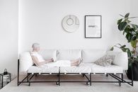 Man in White T-shirt and White Pants Lying on White Couch