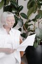 Woman in White Button Up Shirt Holding White Paper